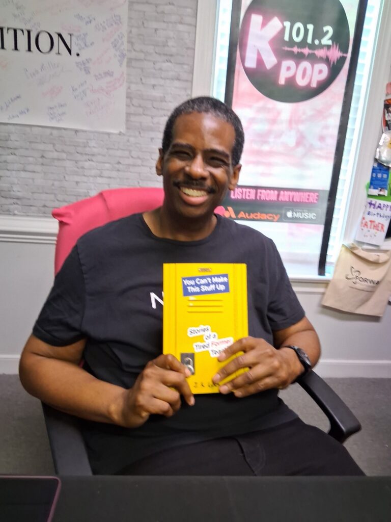 J.K. Lynch holding his new book