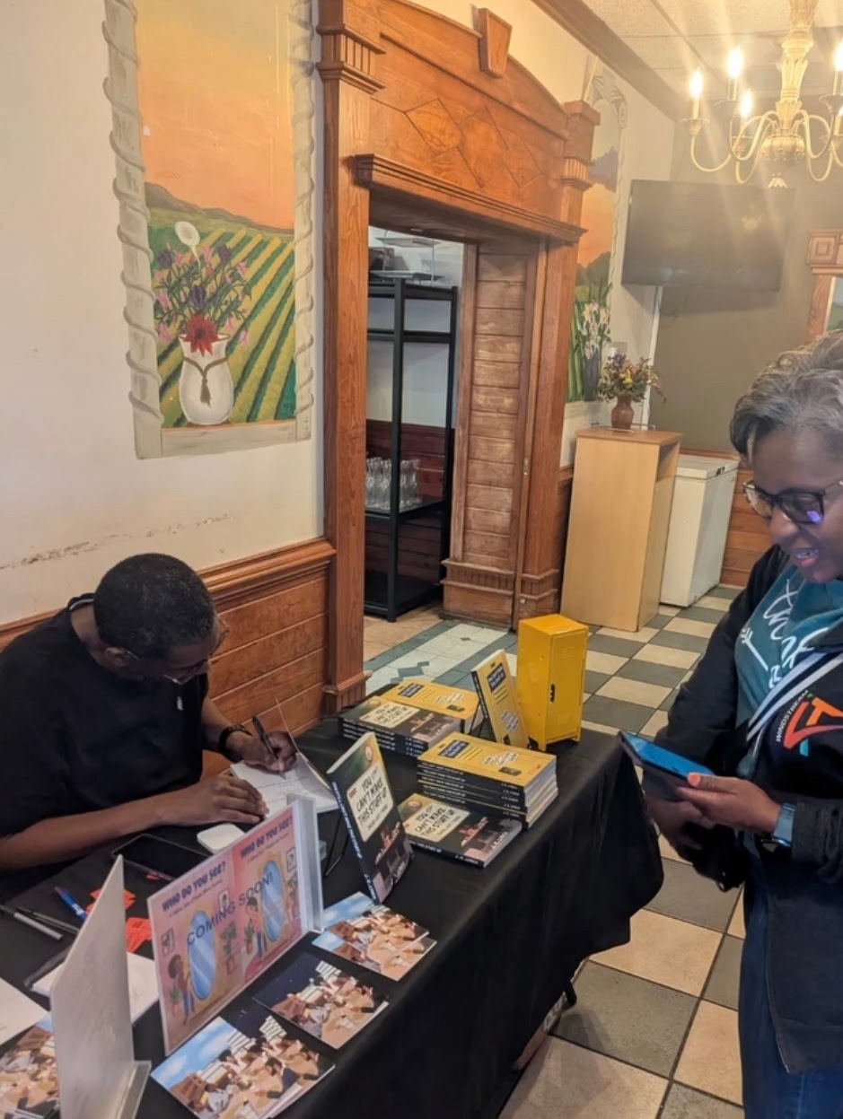 J.K. Lynch signing another copy for a reader
