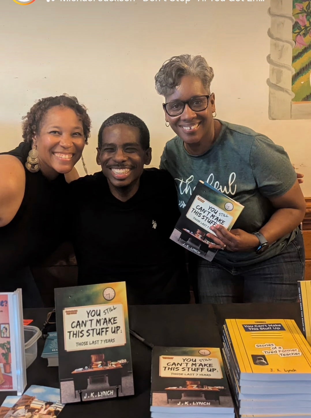 J.K. Lynch with supporters holding his book